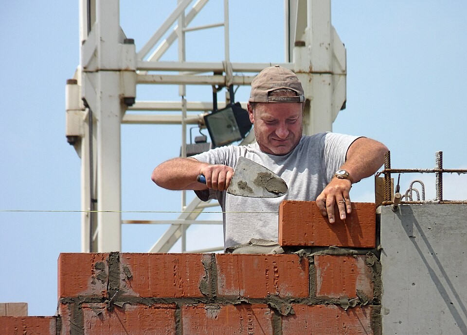 Bricklayer or mason at work on a construction site in Belgium