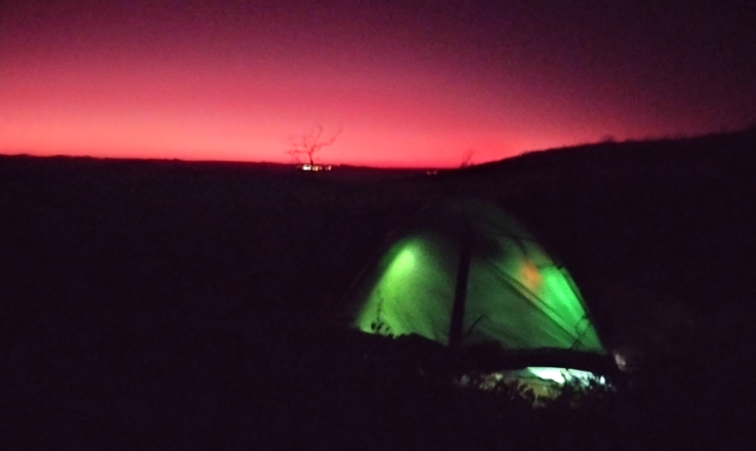 The green glow of Elise & Phil's tent against the pre-dawn eastern horizon